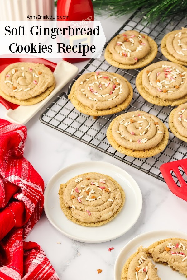 A wire rack of soft gingerbread cookies in the upper right, a cookie on a napkin is to the left. There is a cookie on the white plate in front of the rack, a second cookie to the lower right. There is a red napkin in the lower left.