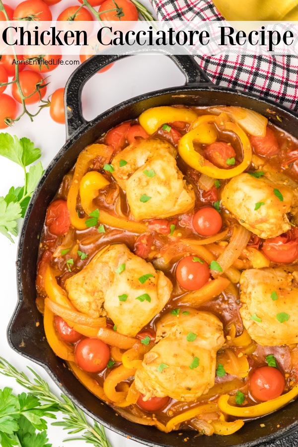 An overhead view of a half of a skillet filled with chicken cacciatore. There are tomatoes in the upper left, a plate of orzo in the upper right.