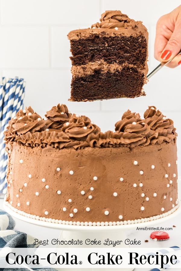 side view of a coca-cola cake on a white platter, a piece is being lifted on a cake lifter