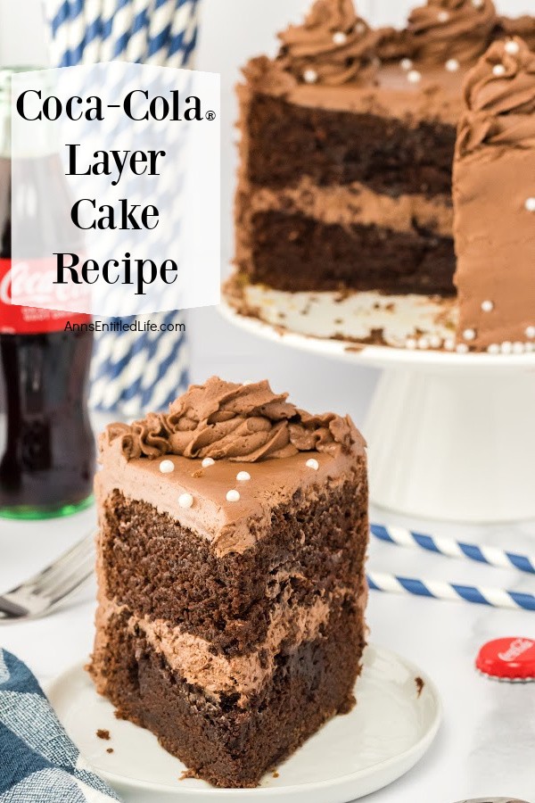 a piece of coca-cola cake on a white plate sits front and center, the rest of the cake is in the upper right