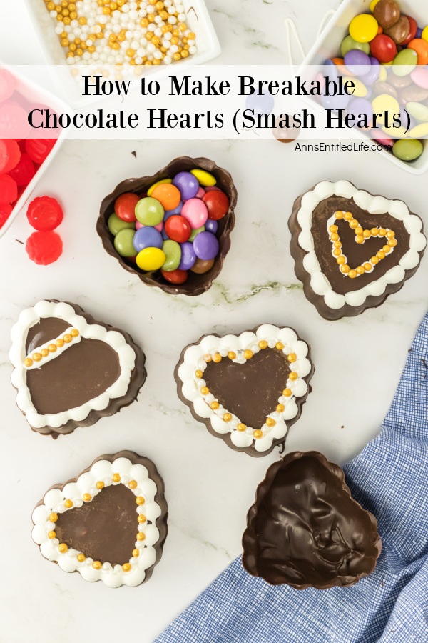 An overhead view of six dark chocolate hearts sitting on a white platter.