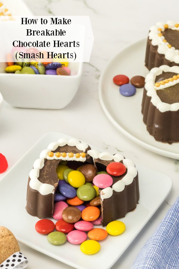 A smashed heart sits front and center on a white plate. There are more unbroken hearts in the upper right, a bowl of M&Ms is in the upper left.