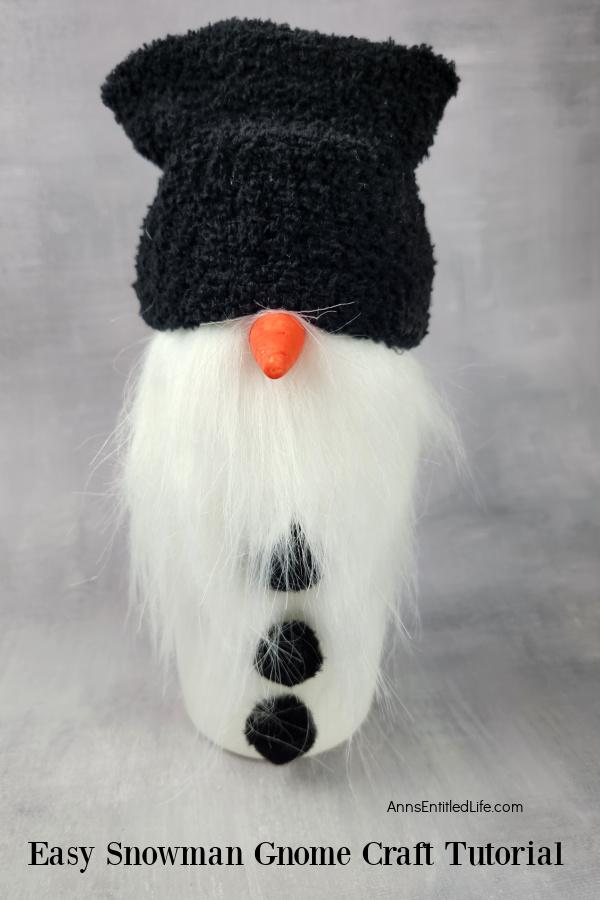 Homemade snowman gnome set against a grey background