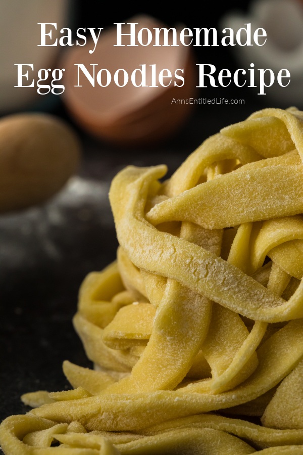 A large pile of homemade egg noodles on a black surface