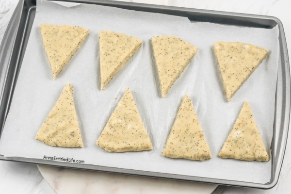 Lemon Poppy Seed Scones Recipe with Glaze. This lemon poppy seed scones recipe features a delicious lemon glaze. The result is moist scones bursting with poppy seeds and freshly grated lemon zest. This lemon-flavored scones recipe goes well with afternoon tea or morning coffee.