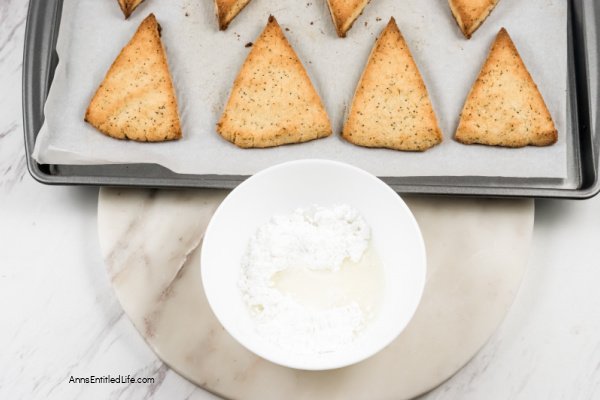 Lemon Poppy Seed Scones Recipe with Glaze. This lemon poppy seed scones recipe features a delicious lemon glaze. The result is moist scones bursting with poppy seeds and freshly grated lemon zest. This lemon-flavored scones recipe goes well with afternoon tea or morning coffee.