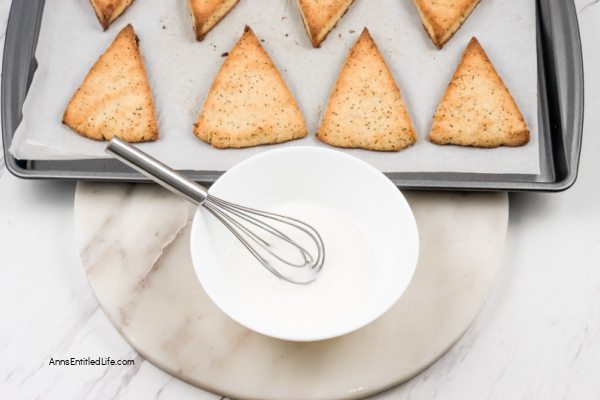 Lemon Poppy Seed Scones Recipe with Glaze. This lemon poppy seed scones recipe features a delicious lemon glaze. The result is moist scones bursting with poppy seeds and freshly grated lemon zest. This lemon-flavored scones recipe goes well with afternoon tea or morning coffee.