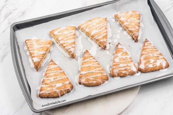 Lemon Poppy Seed Scones Recipe with Glaze. This lemon poppy seed scones recipe features a delicious lemon glaze. The result is moist scones bursting with poppy seeds and freshly grated lemon zest. This lemon-flavored scones recipe goes well with afternoon tea or morning coffee.