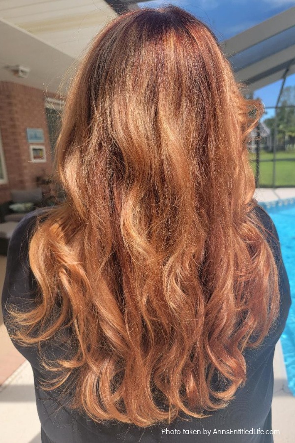A woman (me0 with long red hair.
