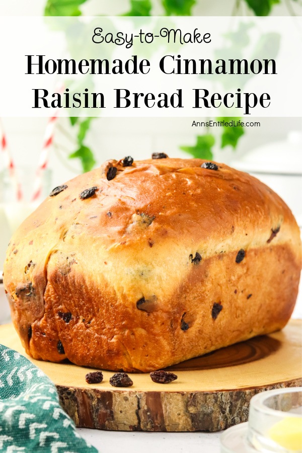 A side view of a whole loaf of cinnamon raisin bread on a wooden cutting board.