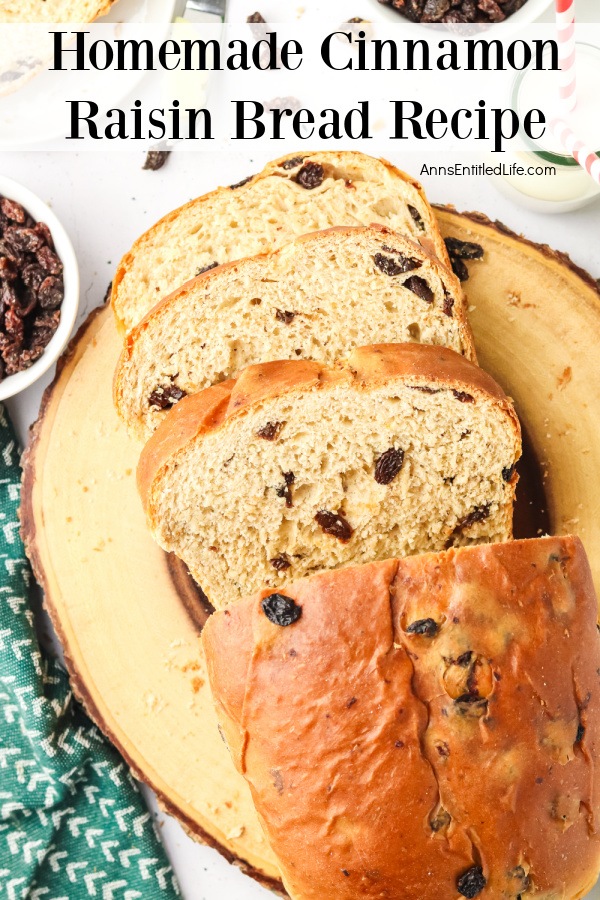 Overhead view of a sliced cinnamon raisin bread on a wooden cutting board.
