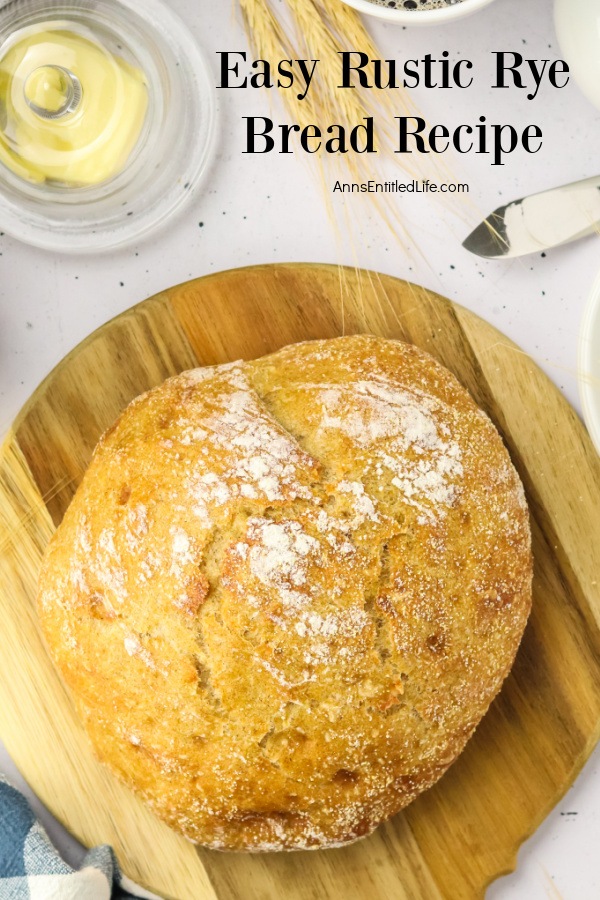 Overhead view of a whole loaf of homemade rye bread on a cutting board.