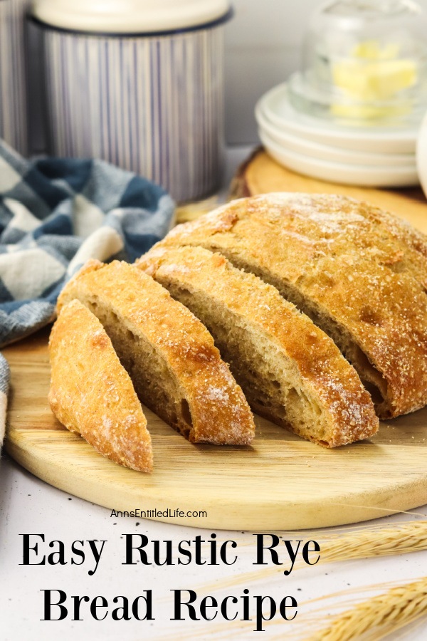 Profile view of a cut loaf of homemade rye bread on a cutting board.