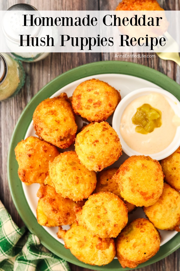 Up close view of Cheddar hush puppies and a white bowl filled with chili aioli in a white and green bowl