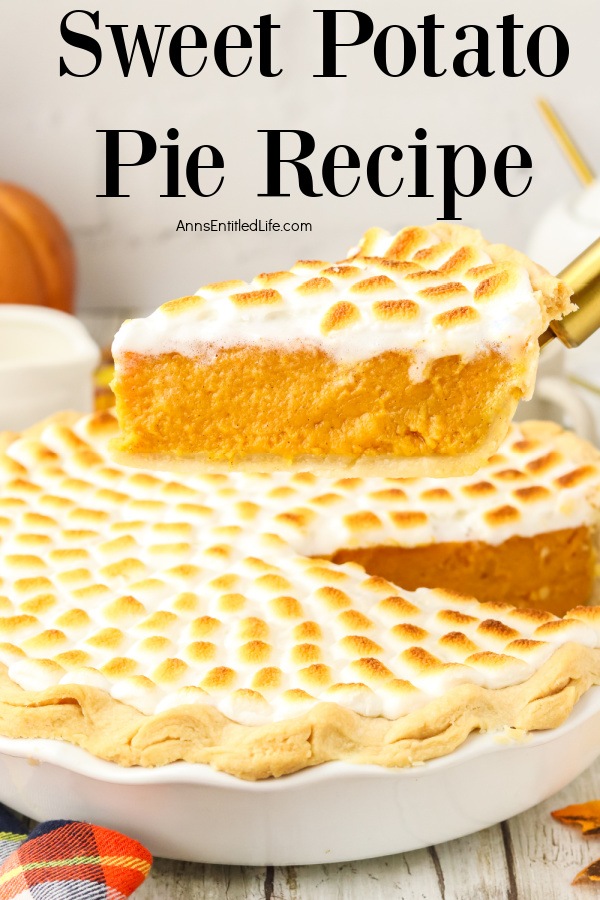 An profile view of a pie of sweet potato pie being lifted from whole sweet potato pie with mini marshmallow topping in a white pie dish below