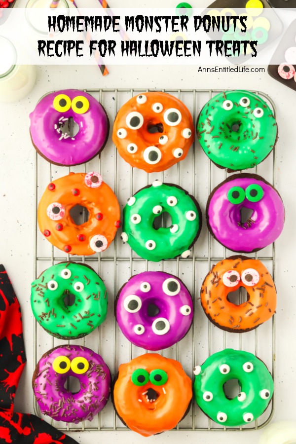 An overhead view wire rack filled with chocolate donuts decorated in Halloween colors and decorations