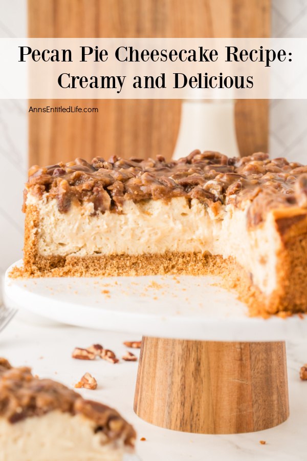 Pecan Pie Cheesecake Recipe: Creamy and Delicious A side view of a cut pecan pie cheesecake set on a white cake plate. There is a cut piece on a plate in the forefront.