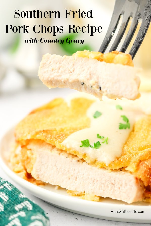 A cut southern fried pork chop on a white plate with a piece on a fork above the plate