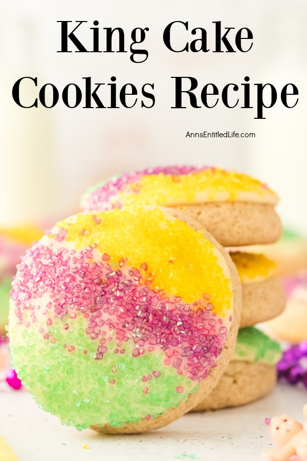 Four king cake cookies on a white surface, three stacked, one forward facing.