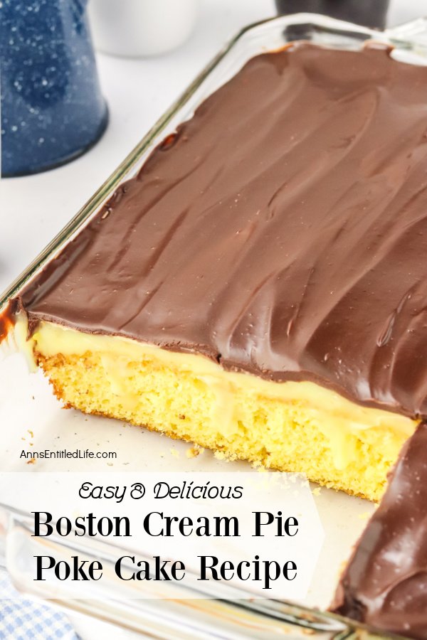 A Boston vream pie poke cake in a glass 13x9 pan with two pieces removed