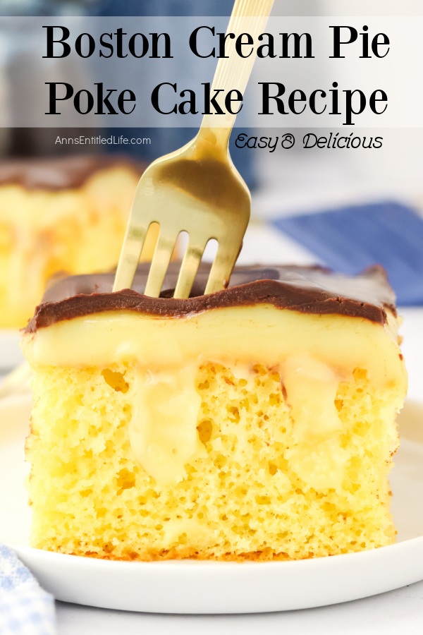 A profile view of a piece of Boston cream pie poke cake with a fork embedded, on a white plate