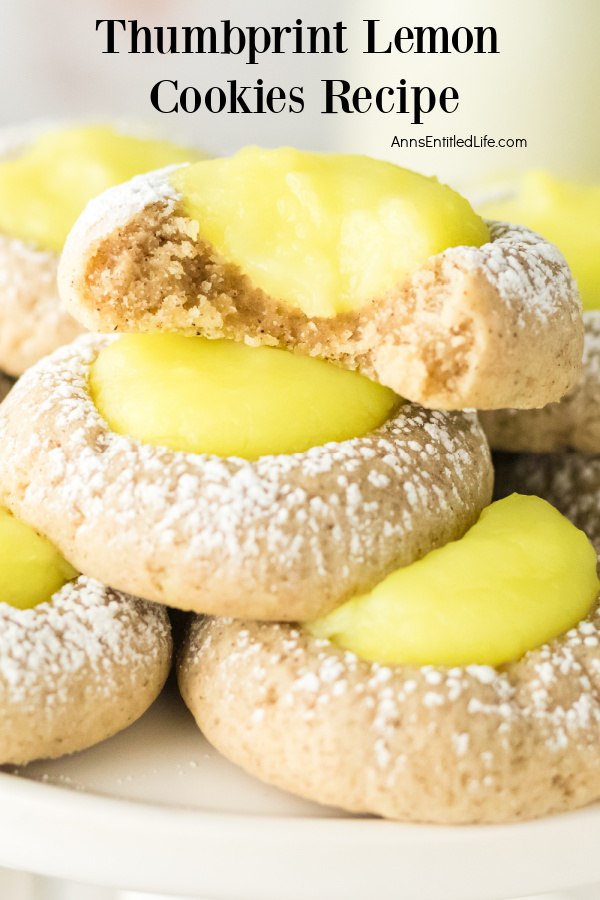 Close-up of a stack of thumbprint lemon cookies on a white plate