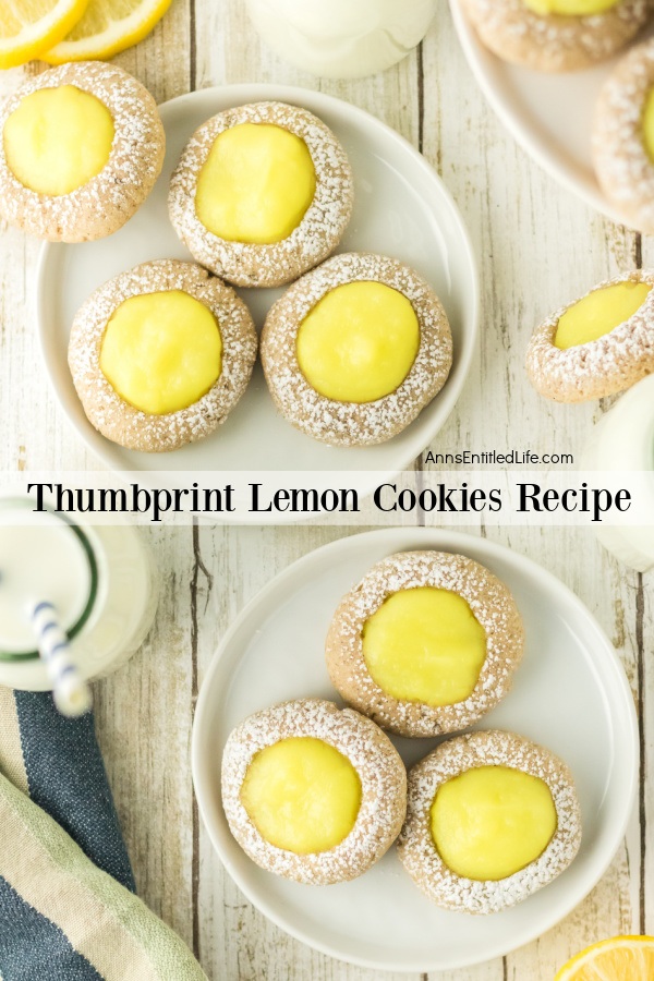 There are two small white plates each with three thumbprint lemon cookies. A third plate can be partially seen in the upper right, partial lemon slices in the upper left, partial milk bottle and napkin lower left, all set atop a rustic board.