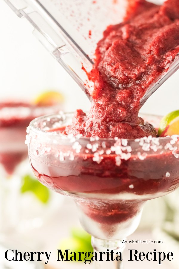 A frozen cherry margarita being poured from a blender into the margarita glass below.