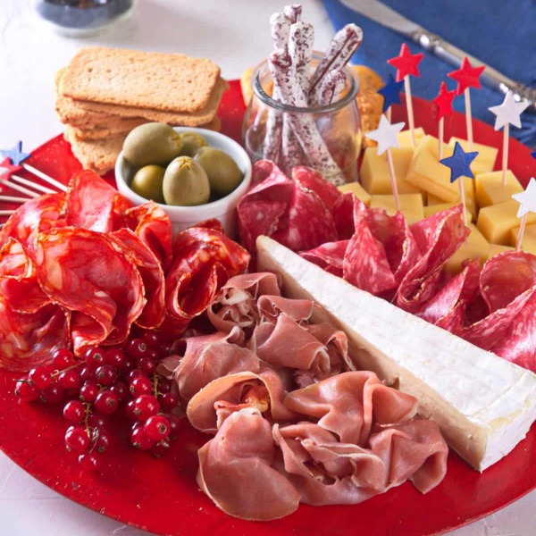 Build a stunning 4th of July Charcuterie Board the adults will love! Featuring savory meats, creamy cheeses, fresh summer berries, honeycomb, pistachios, and festive red-white-blue accents for your patriotic celebration.