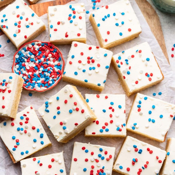 These soft, chewy Red White and Blue Sugar Cookie Bars are the perfect patriotic dessert for your America 250 party or July 4, 2026 celebration. A thick, buttery sugar cookie base is topped with creamy vanilla frosting and decorated with red, white, and blue sprinkles for a beautiful look. Easy to make in one pan, these cookie bars are ideal for Semiquincentennial picnics, block parties, and America’s Block Party gatherings.