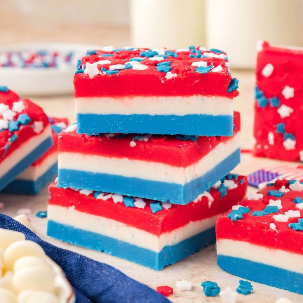 Made with just a few simple ingredients like white chocolate chips, sweetened condensed milk, and flavor extracts or food coloring, this easy Red White and Blue Layered Fudge comes together quickly and sets in the fridge. It’s rich yet sliceable, kid-friendly, and travels perfectly for block parties, picnics, or America’s Block Party events.