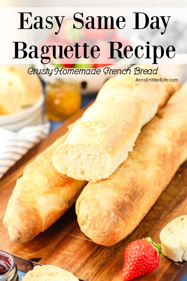 Three homemade French baguettes on a cutting board, the top one is cut