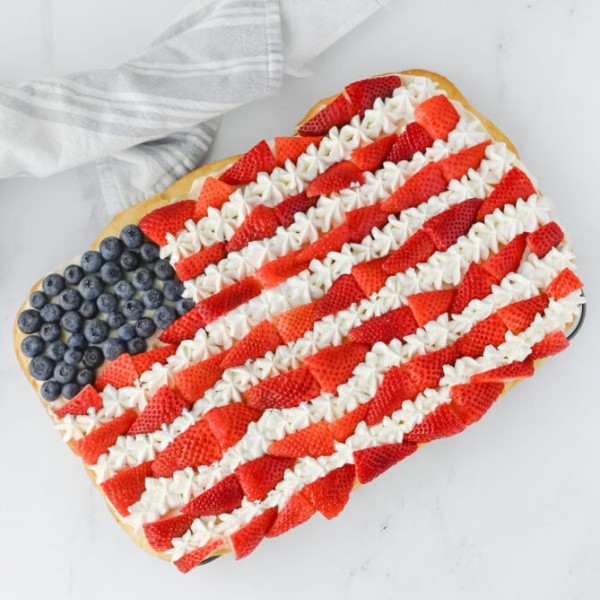 Make this stunning Red, White, and Blue Dessert Fruit Pizza with a buttery cookie base, sweet cream cheese frosting, and vibrant strawberries and blueberries. A fun, refreshing patriotic treat for summer holidays!