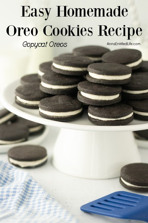 A white cake plate is filled with stacks of homemade Oreo cookies