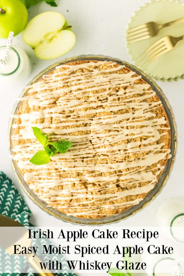 Overhead image of a whole Irish apple cake. There are granny smith apples in the upper left, plates and forks in the upper right.