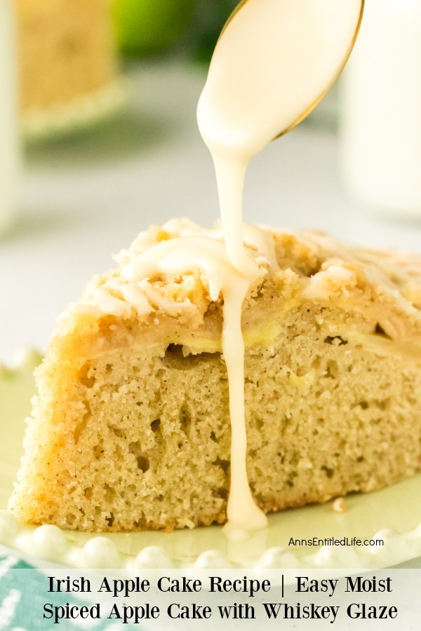 A piece of Irish apple cake is being drizzled with a whiskey glaze