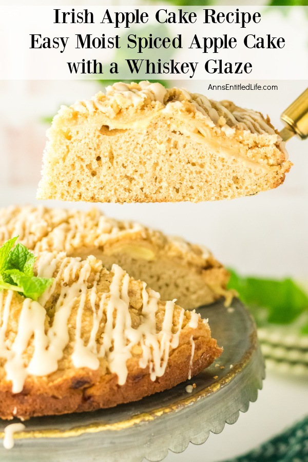 A piece of Irish apple cake is being lifted from the whole cake below